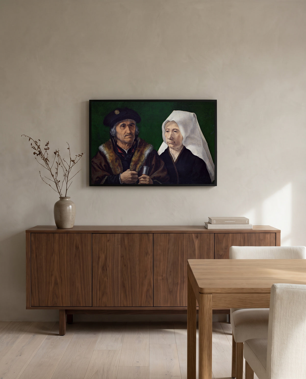 An Elderly Couple by Jan Gossaert in a black frame above a walnut sideboard in a dining room