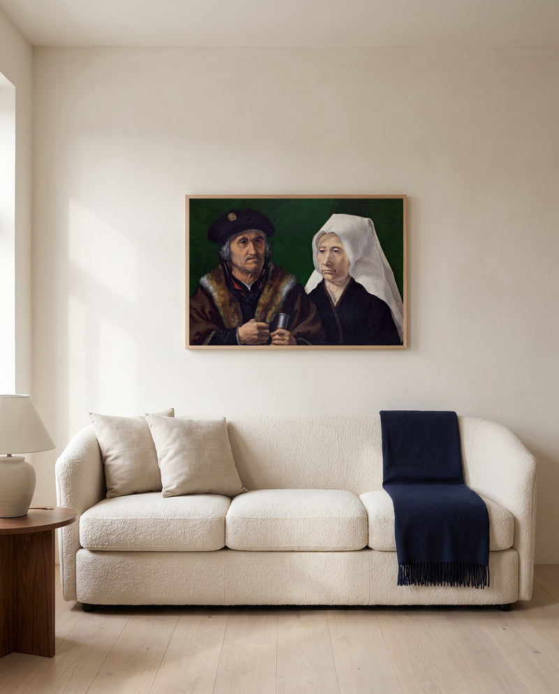 An Elderly Couple by Jan Gossaert framed in natural oak above a cream sofa in a warm living room
