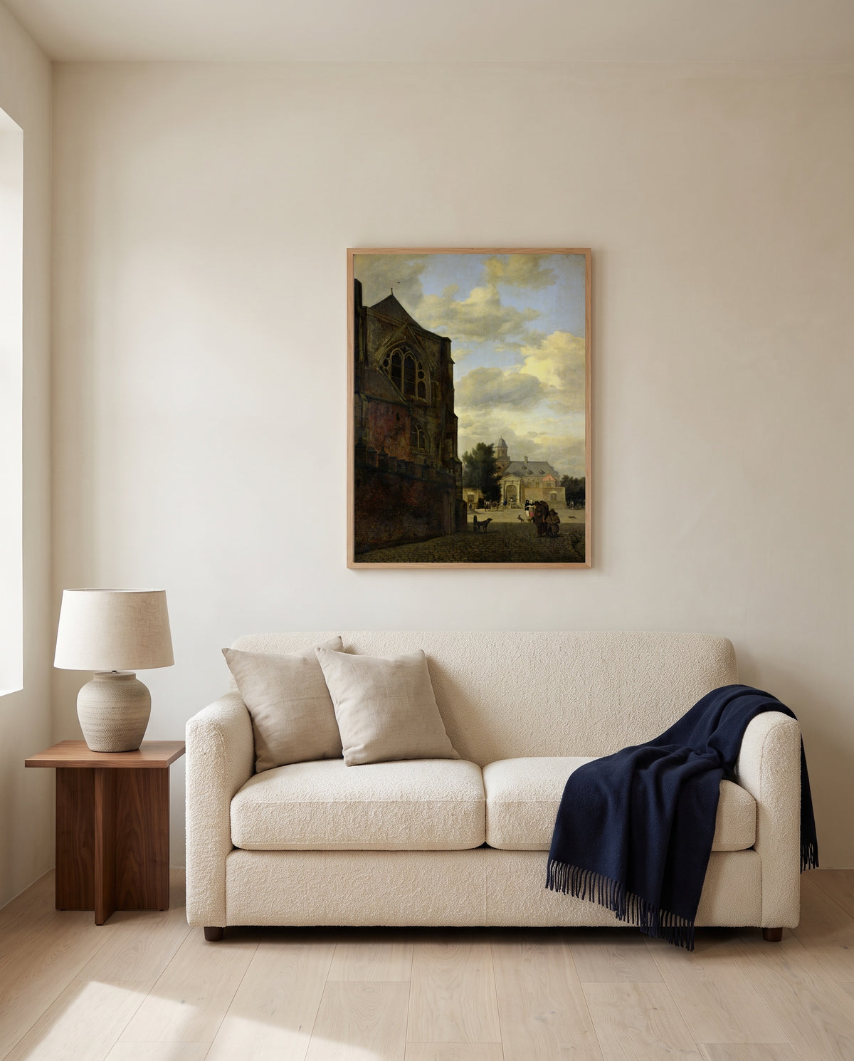 View of Nijenrode Castle by Jan van der Heyden framed in natural oak above a cream sofa in a warm living room