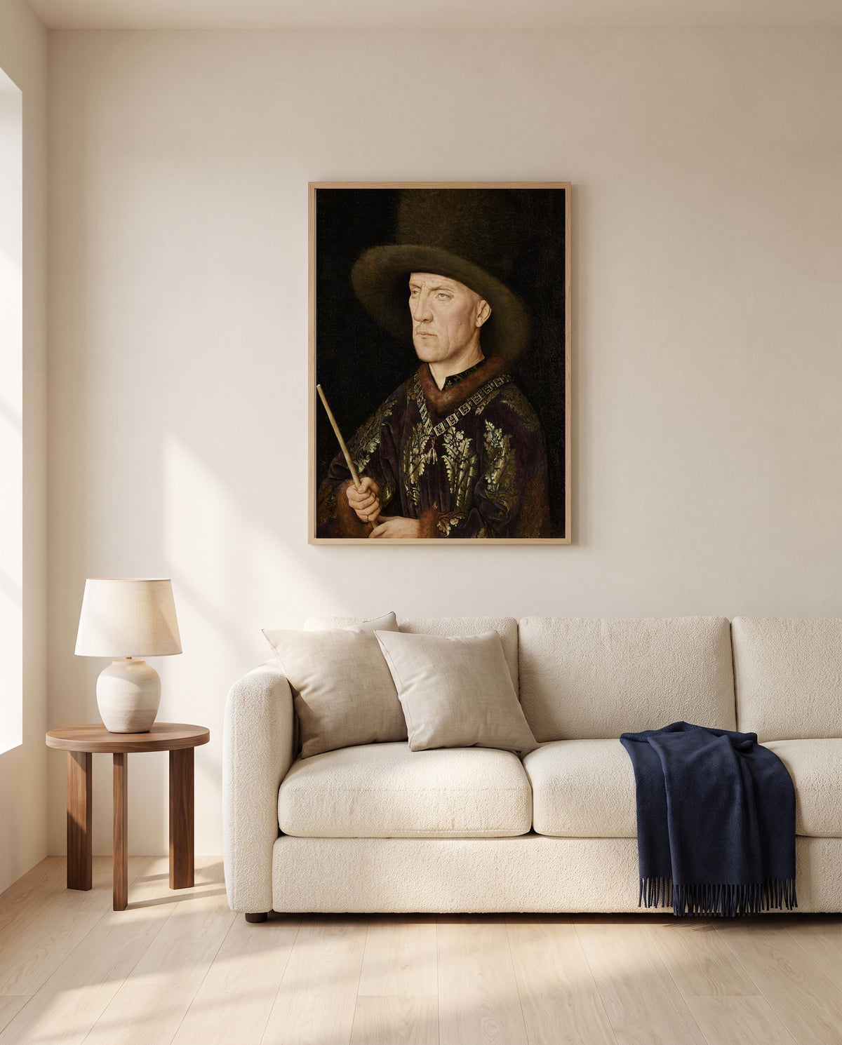 Baudouin de Lannoy by Jan van Eyck framed in natural oak above a cream sofa in a warm living room