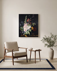 Hollyhocks in a Vase by Jan van Huysum as a stretched canvas above a linen lounge chair in a reading corner