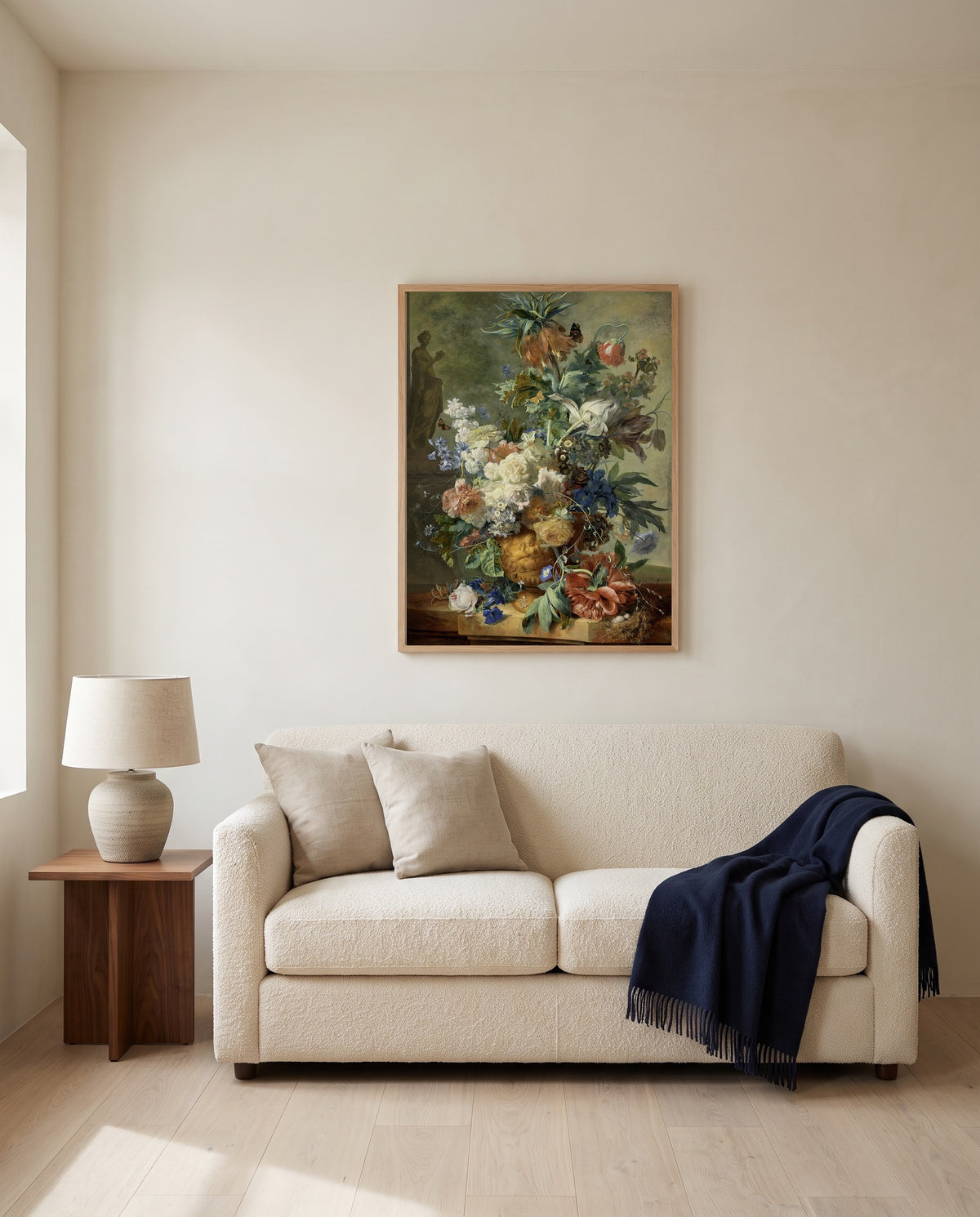 Still Life with Flowers by Jan van Huysum framed in natural oak above a cream sofa in a warm living room