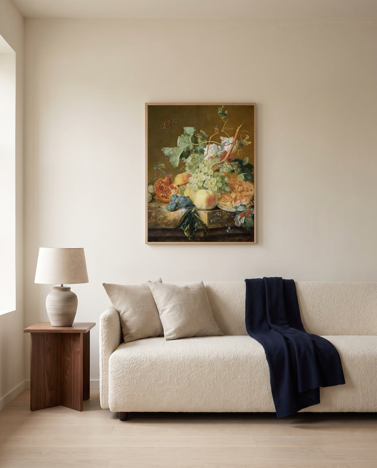 Still Life with Fruit by Jan van Huysum framed in natural oak above a cream sofa in a warm living room