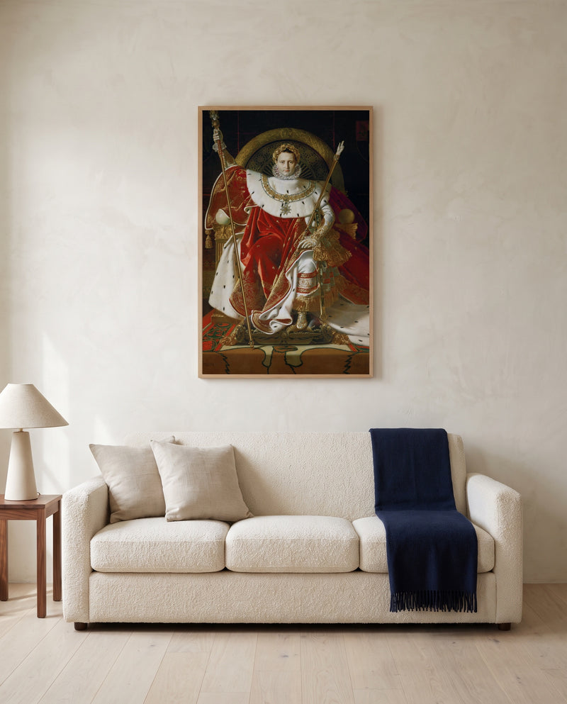 Napoleon on His Throne by Jean-Auguste-Dominique Ingres framed in natural oak above a cream sofa in a warm living room