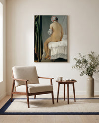 The Valpinçon Bather by Jean-Auguste-Dominique Ingres as a stretched canvas above a linen lounge chair in a reading corner