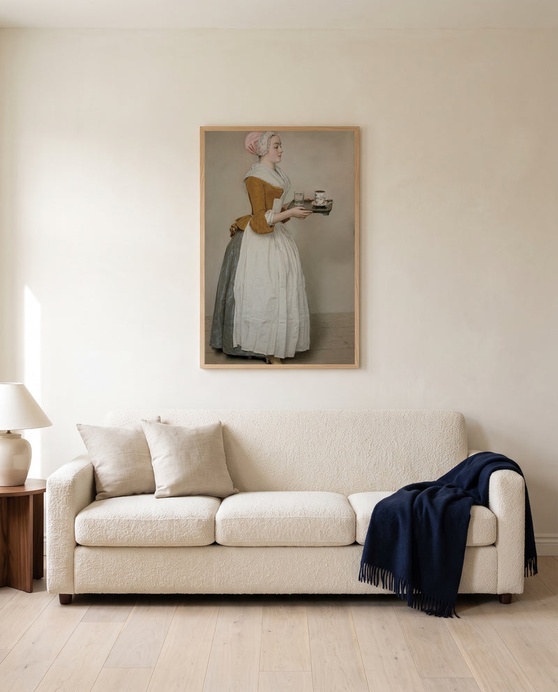 The Chocolate Girl by Jean-Étienne Liotard framed in natural oak above a cream sofa in a warm living room