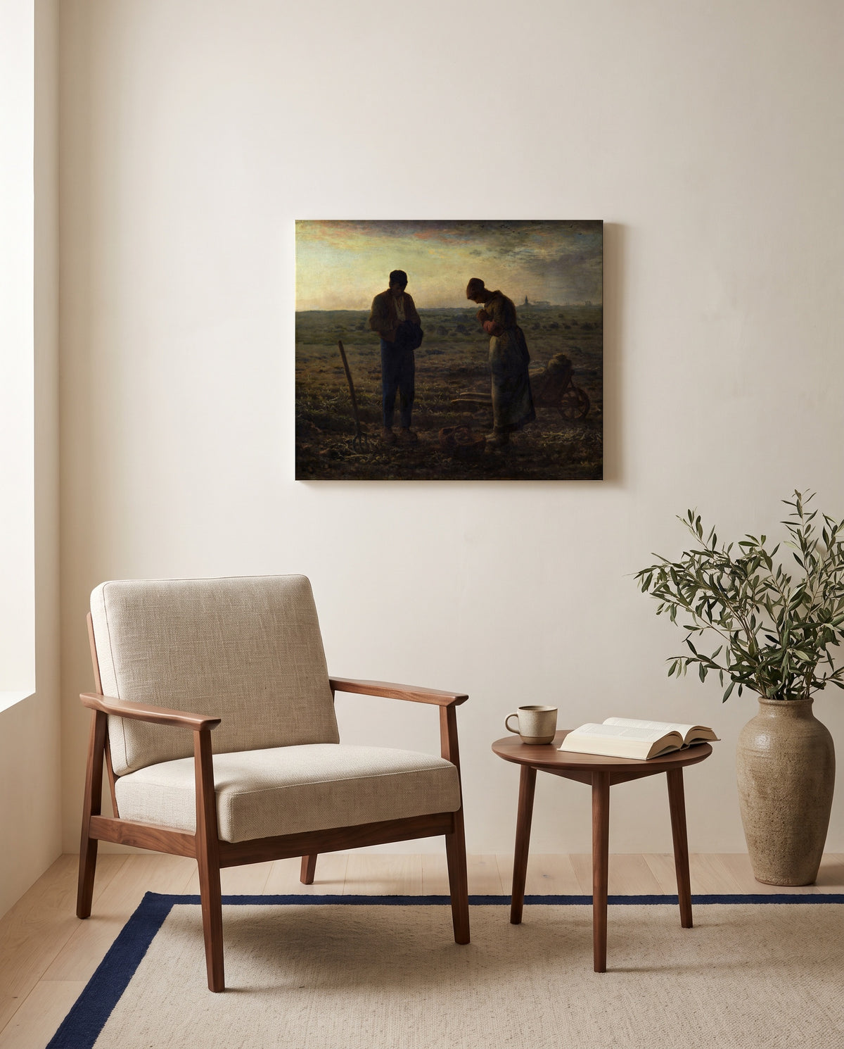 The Angelus by Jean-François Millet as a stretched canvas above a linen lounge chair in a reading corner