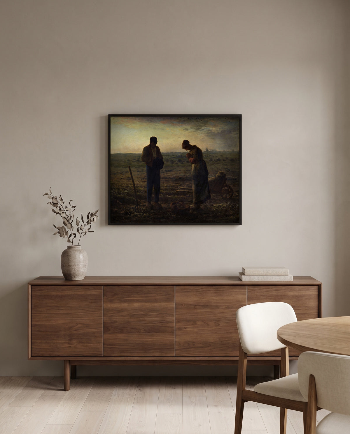 The Angelus by Jean-François Millet in a black frame above a walnut sideboard in a dining room