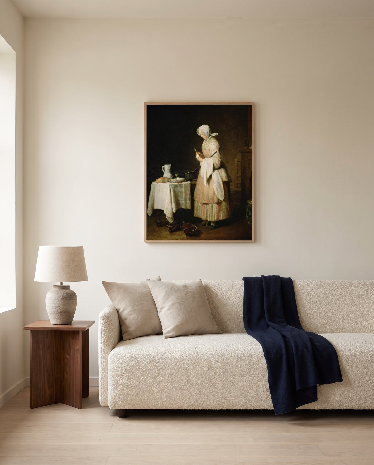 The Attentive Nurse by Jean Siméon Chardin framed in natural oak above a cream sofa in a warm living room