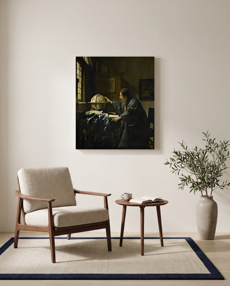 The Astronomer by Johannes Vermeer as a stretched canvas above a linen lounge chair in a reading corner