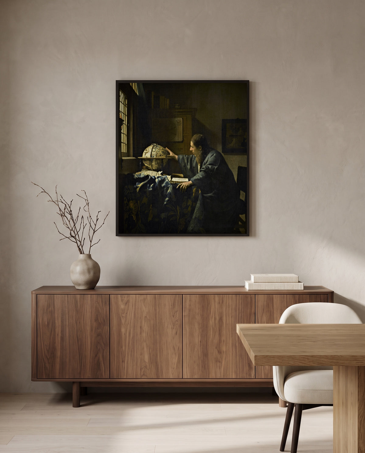 The Astronomer by Johannes Vermeer in a black frame above a walnut sideboard in a dining room