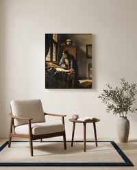 The Geographer by Johannes Vermeer as a stretched canvas above a linen lounge chair in a reading corner
