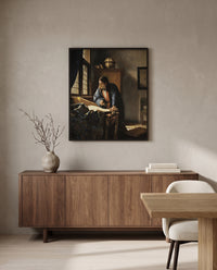 The Geographer by Johannes Vermeer in a black frame above a walnut sideboard in a dining room