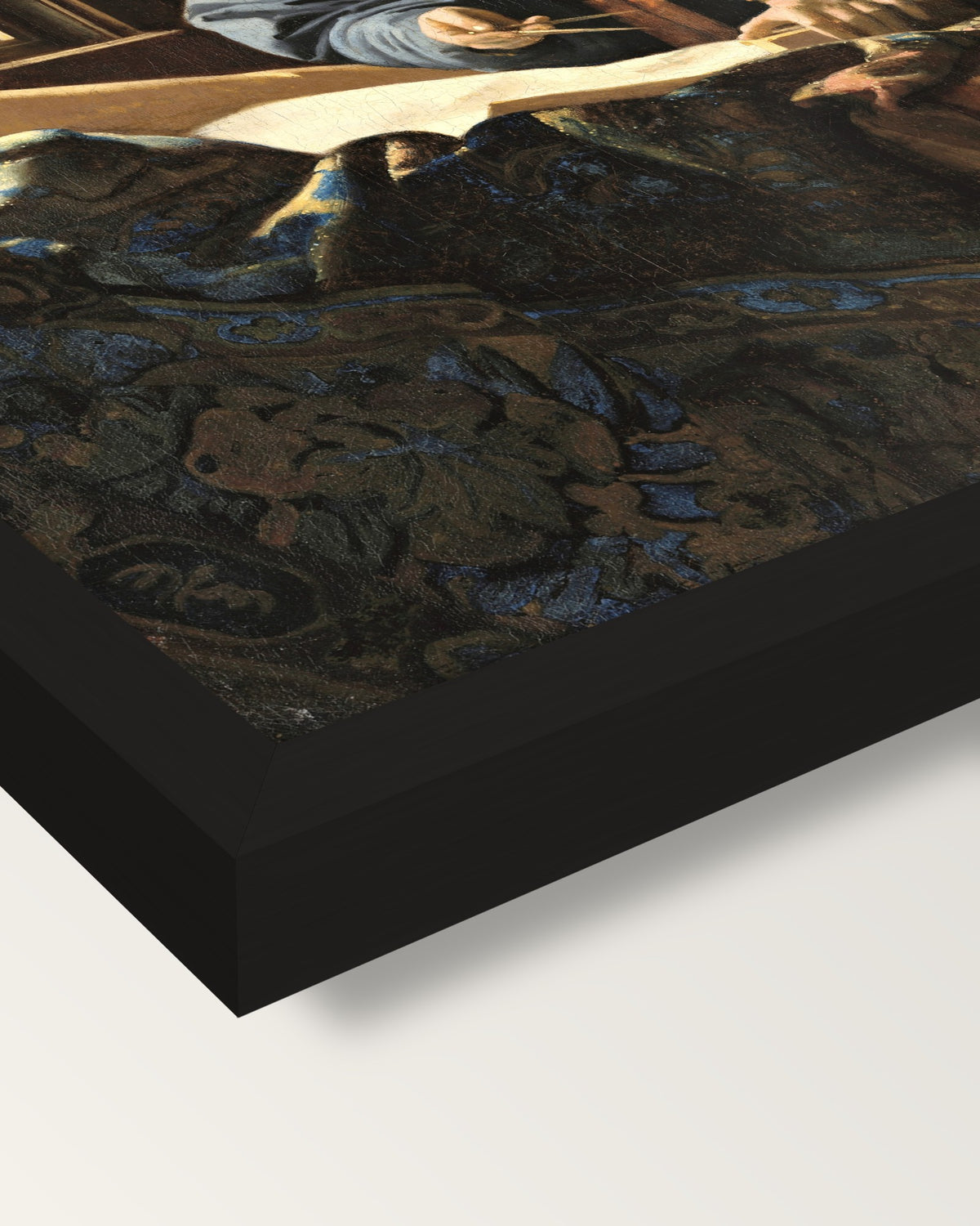 The Geographer by Johannes Vermeer framed print, corner close-up: black moulding, mitred, the print set just below its edge