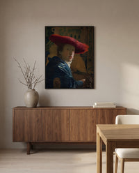 Girl with a Red Hat by Johannes Vermeer in a black frame above a walnut sideboard in a dining room