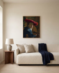 Girl with a Red Hat by Johannes Vermeer framed in natural oak above a cream sofa in a warm living room