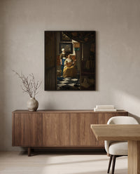 The Love Letter by Johannes Vermeer in a black frame above a walnut sideboard in a dining room