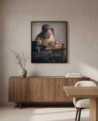 The Lacemaker by Johannes Vermeer in a black frame above a walnut sideboard in a dining room