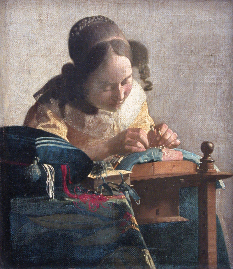 The Lacemaker by Vermeer: a young woman in a yellow bodice bending over her lace pillow, red and white threads spilling out