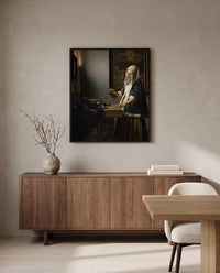 Woman Holding a Balance by Johannes Vermeer in a black frame above a walnut sideboard in a dining room