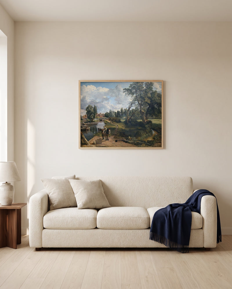 Flatford Mill by John Constable framed in natural oak above a cream sofa in a warm living room