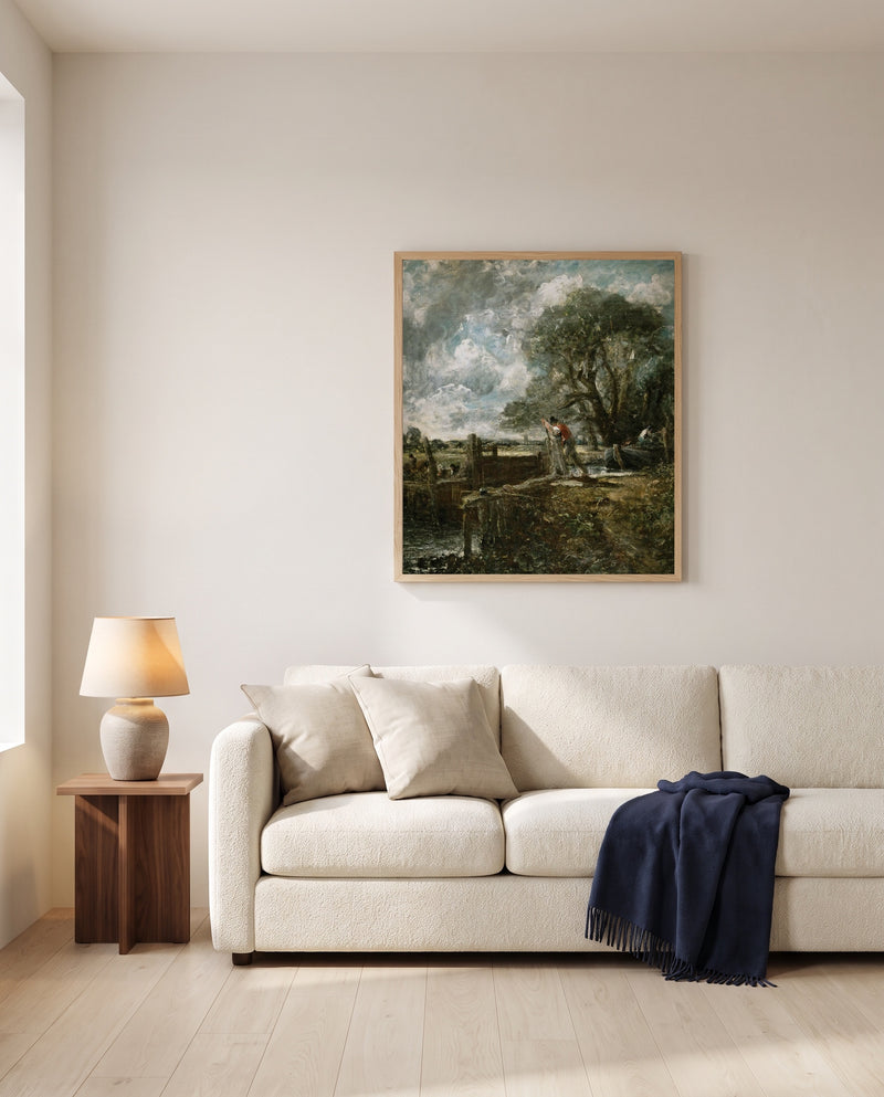 A Boat Passing a Lock by John Constable framed in natural oak above a cream sofa in a warm living room