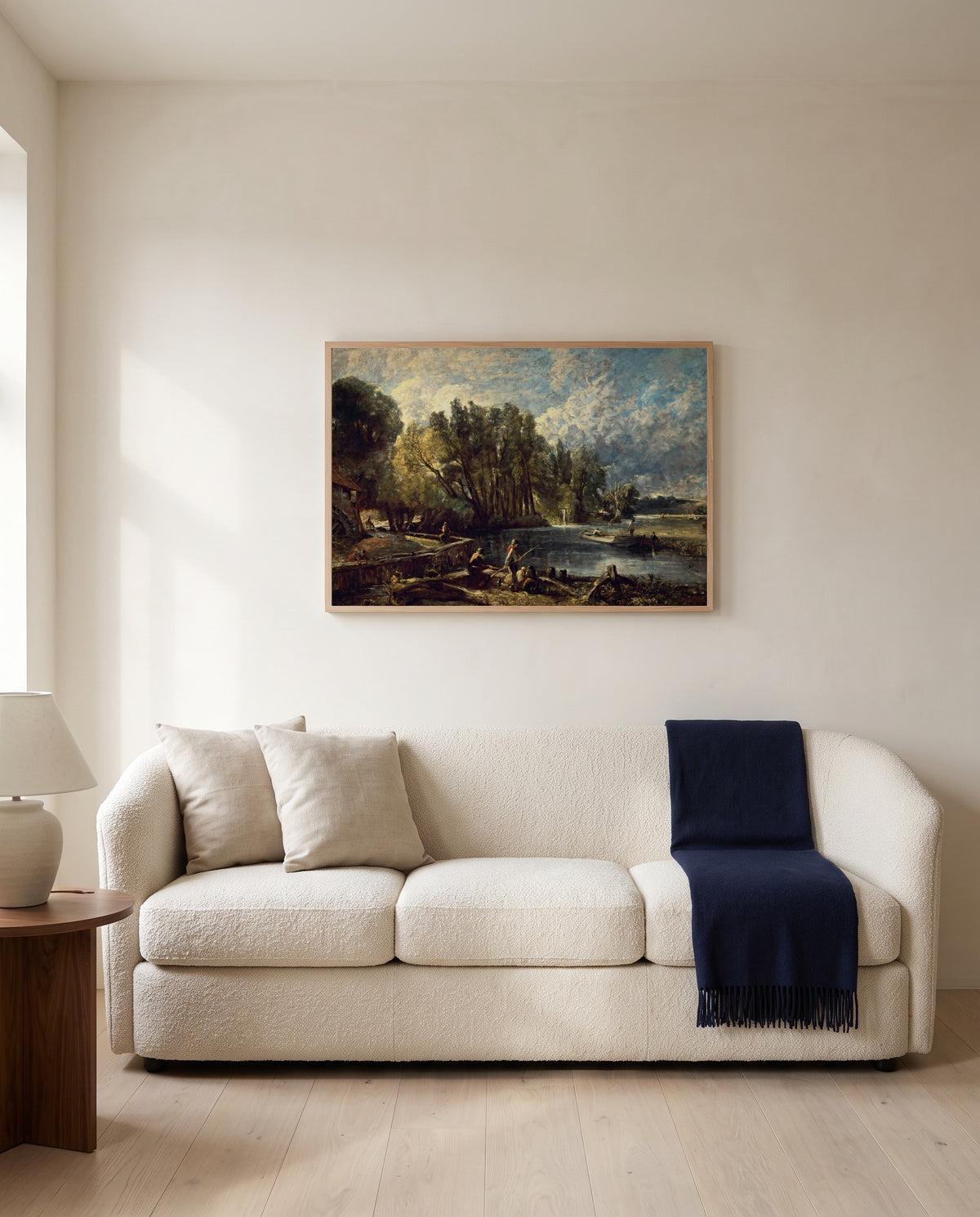 Stratford Mill by John Constable framed in natural oak above a cream sofa in a warm living room
