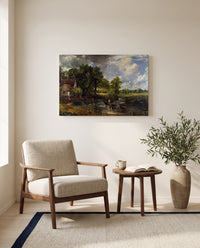 The Hay Wain by John Constable as a stretched canvas above a linen lounge chair in a reading corner
