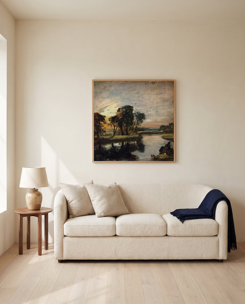 The Stour by John Constable framed in natural oak above a cream sofa in a warm living room