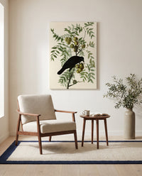 American Crow by John James Audubon as a stretched canvas above a linen lounge chair in a reading corner