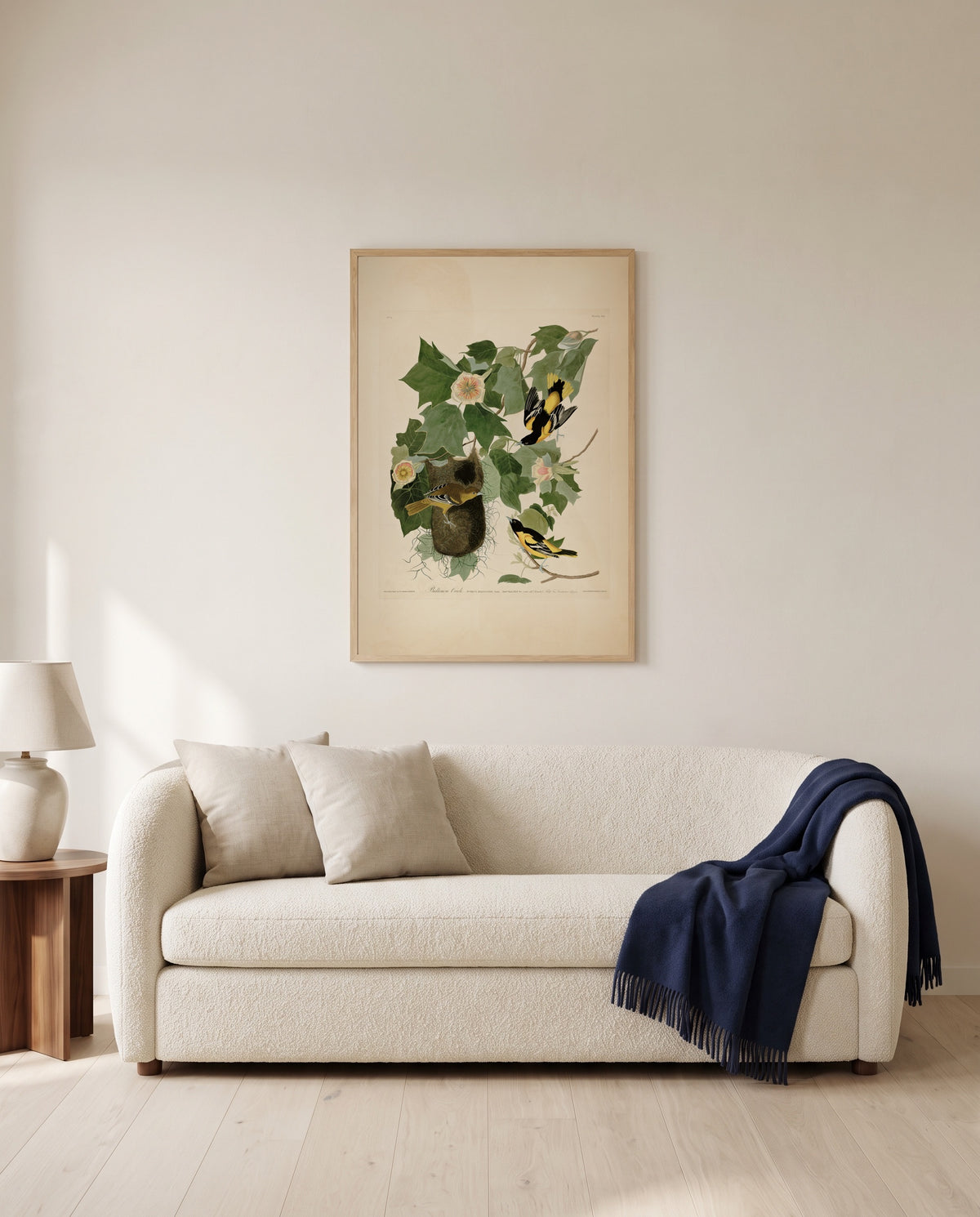 Baltimore Oriole by John James Audubon framed in natural oak above a cream sofa in a warm living room