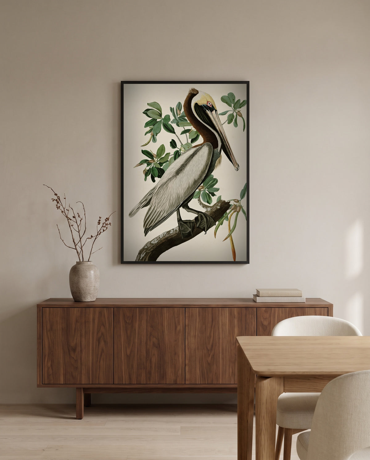 Brown Pelican by John James Audubon in a black frame above a walnut sideboard in a dining room