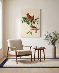Cardinal Grosbeak by John James Audubon as a stretched canvas above a linen lounge chair in a reading corner