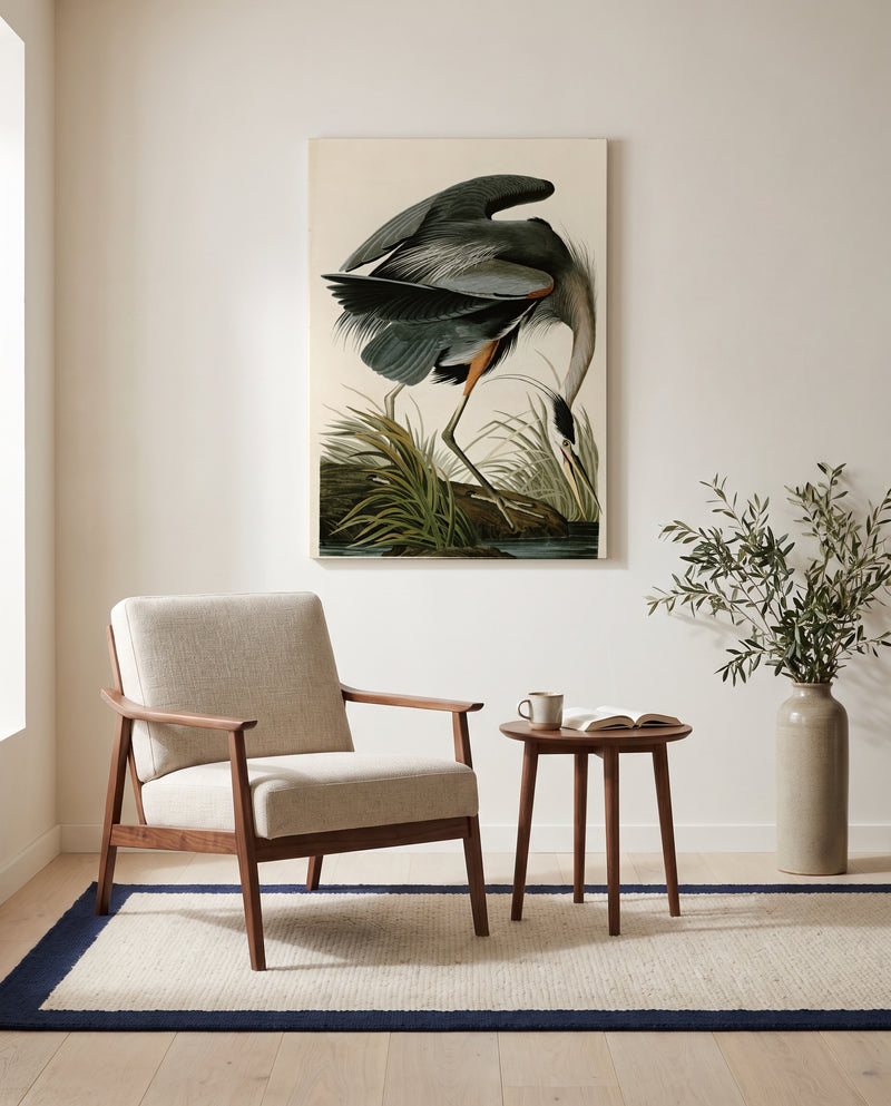 Great Blue Heron by John James Audubon as a stretched canvas above a linen lounge chair in a reading corner