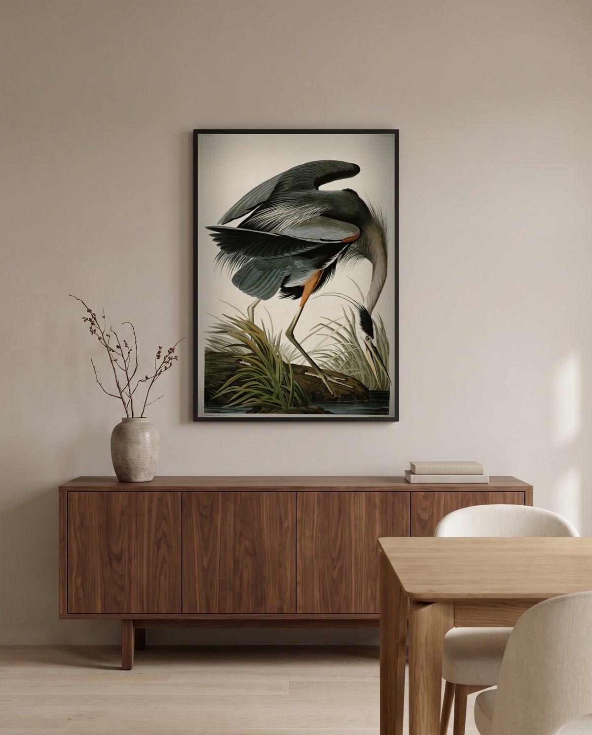 Great Blue Heron by John James Audubon in a black frame above a walnut sideboard in a dining room