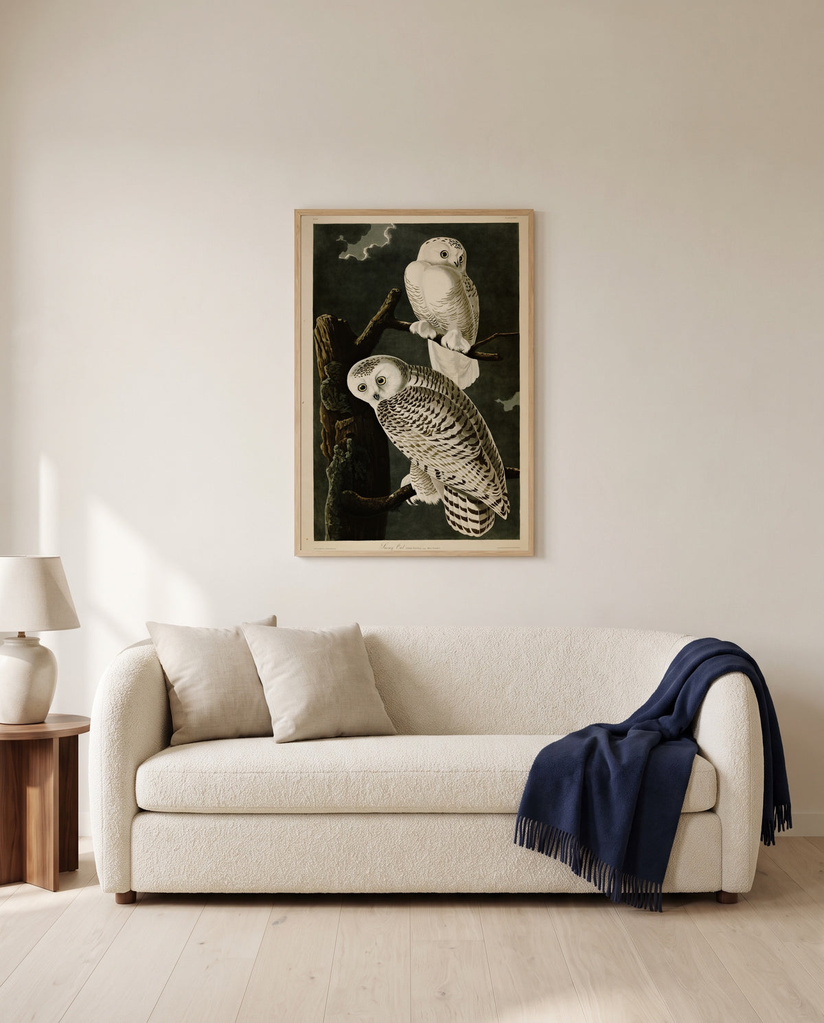 Snowy Owl by John James Audubon framed in natural oak above a cream sofa in a warm living room