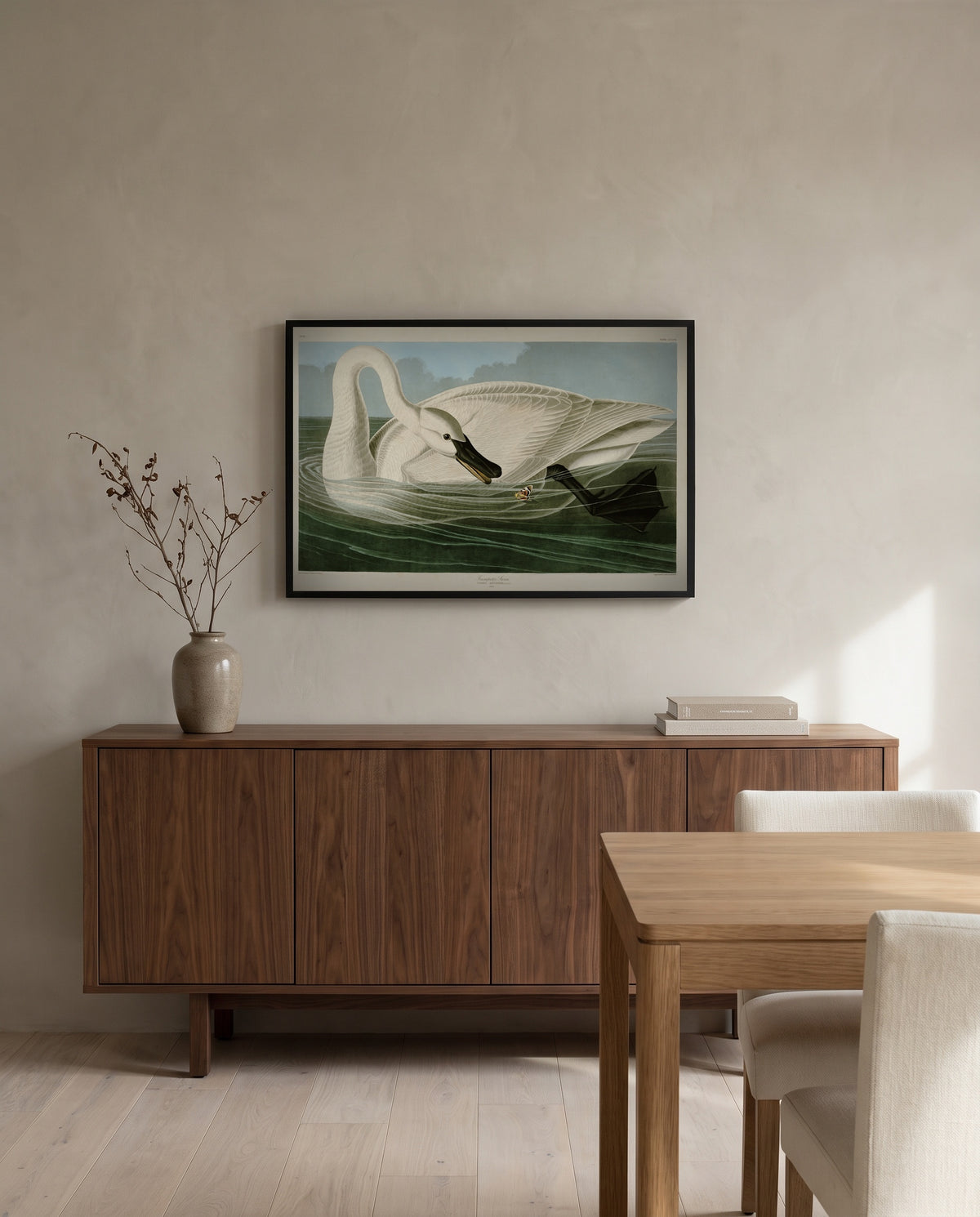 Trumpeter Swan by John James Audubon in a black frame above a walnut sideboard in a dining room
