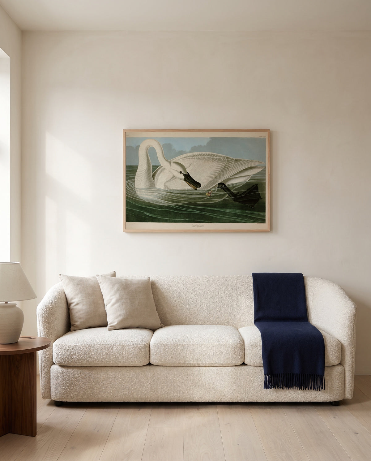 Trumpeter Swan by John James Audubon framed in natural oak above a cream sofa in a warm living room