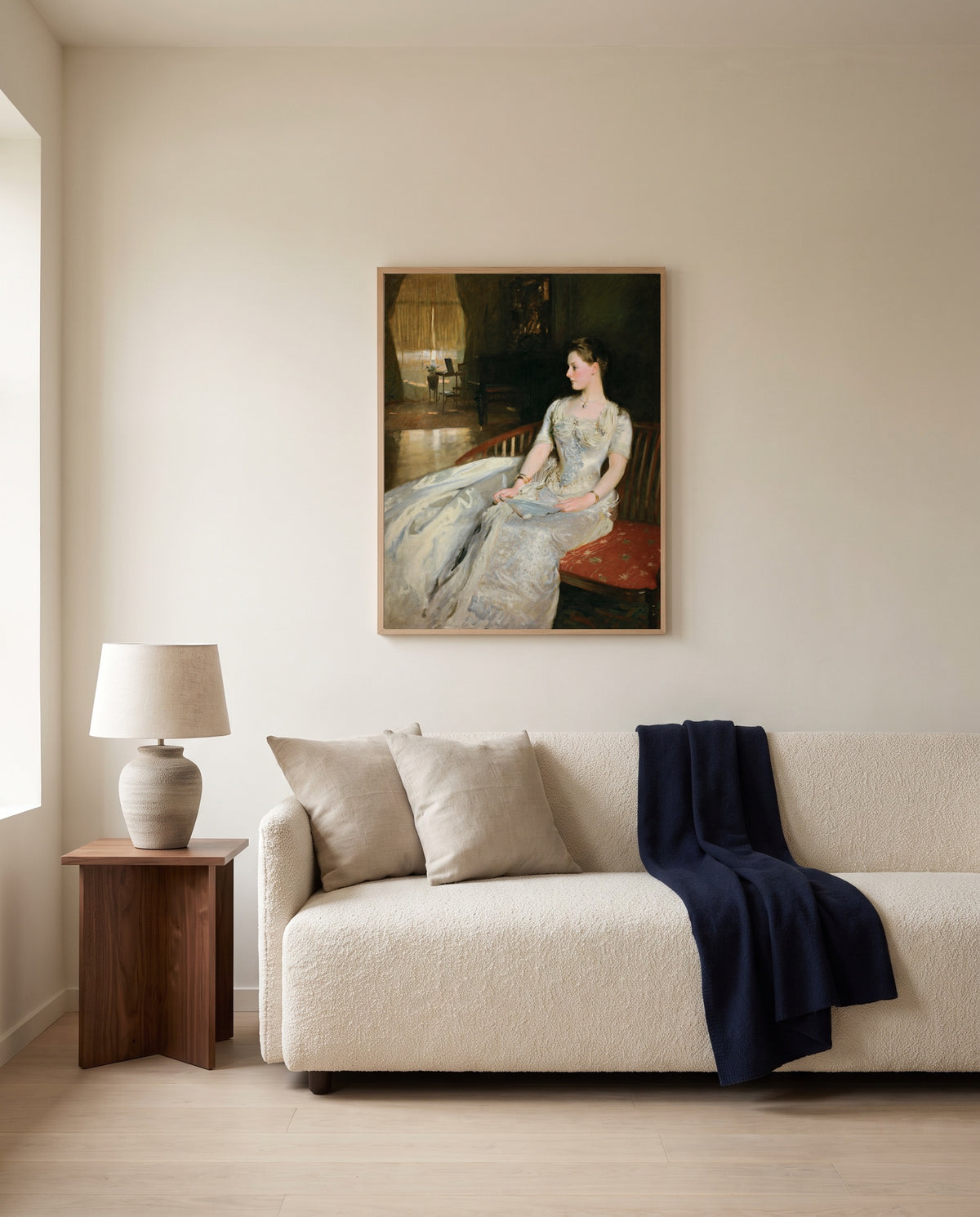Mrs. Cecil Wade by John Singer Sargent framed in natural oak above a cream sofa in a warm living room