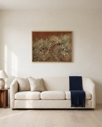 Thistles by John Singer Sargent framed in natural oak above a cream sofa in a warm living room