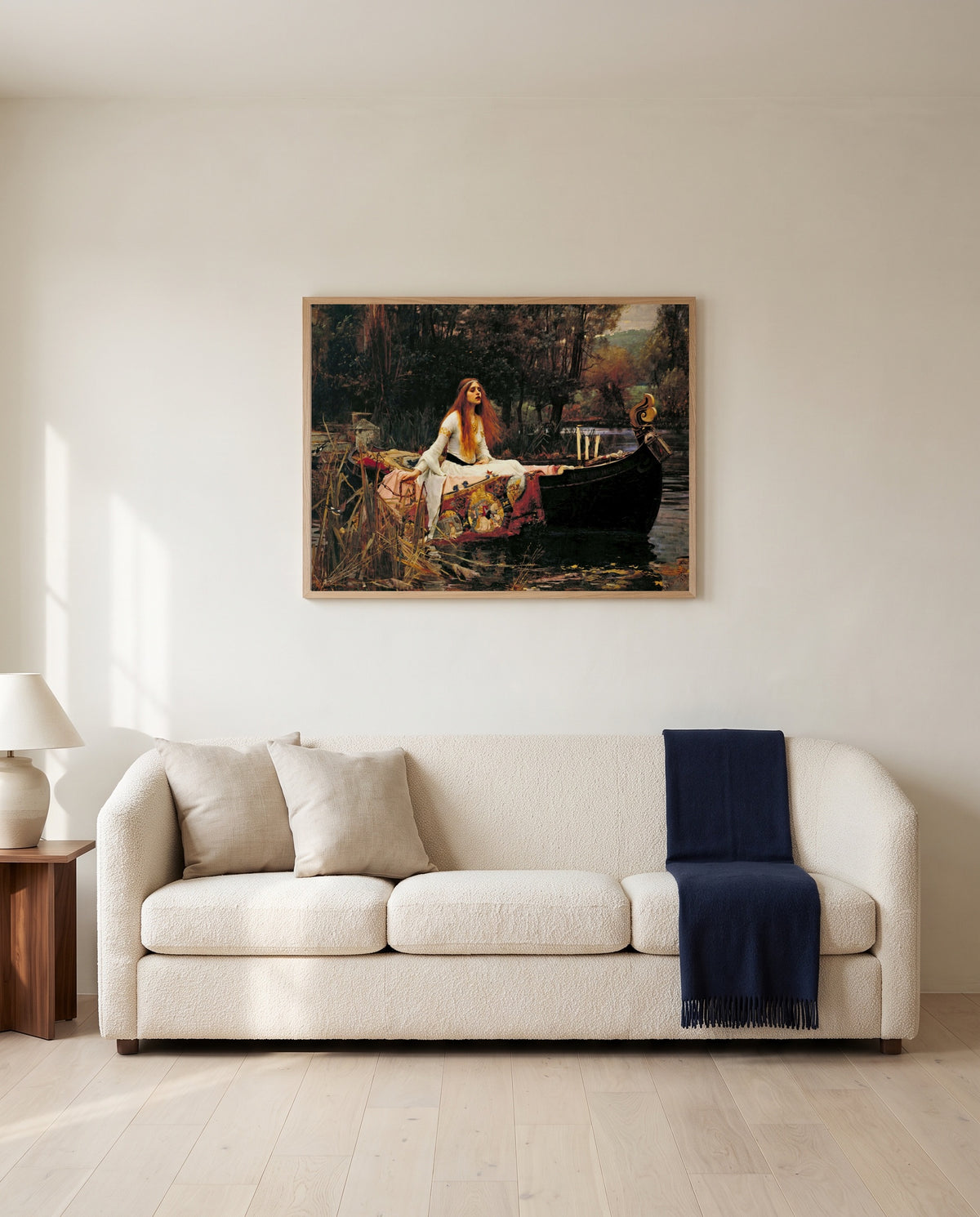 The Lady of Shalott by John William Waterhouse framed in natural oak above a cream sofa in a warm living room