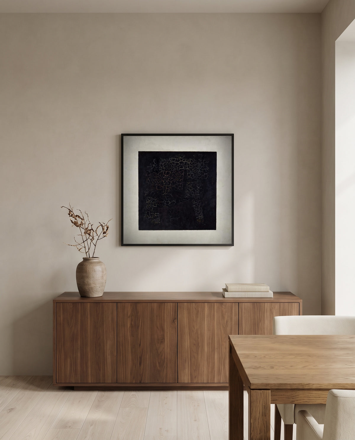 Black Square by Kazimir Malevich in a black frame above a walnut sideboard in a dining room