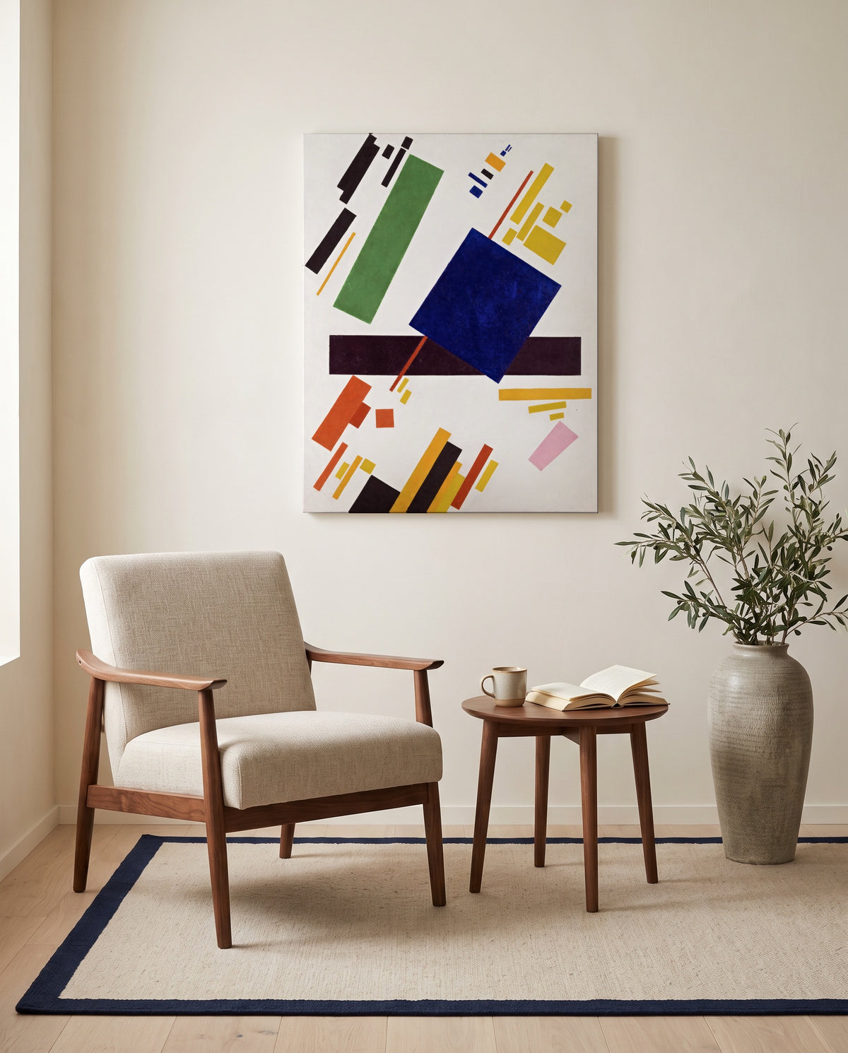 Suprematist Composition by Kazimir Malevich as a stretched canvas above a linen lounge chair in a reading corner