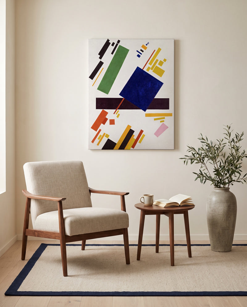 Suprematist Composition by Kazimir Malevich as a stretched canvas above a linen lounge chair in a reading corner