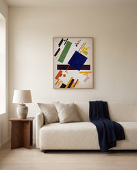 Suprematist Composition by Kazimir Malevich framed in natural oak above a cream sofa in a warm living room