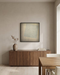 White on White by Kazimir Malevich in a black frame above a walnut sideboard in a dining room