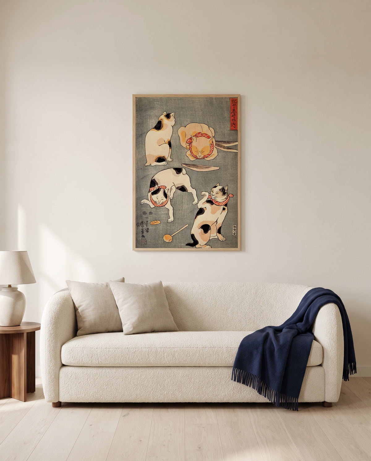 Four Cats (Proverbs) by Utagawa Kuniyoshi framed in natural oak above a cream sofa in a warm living room