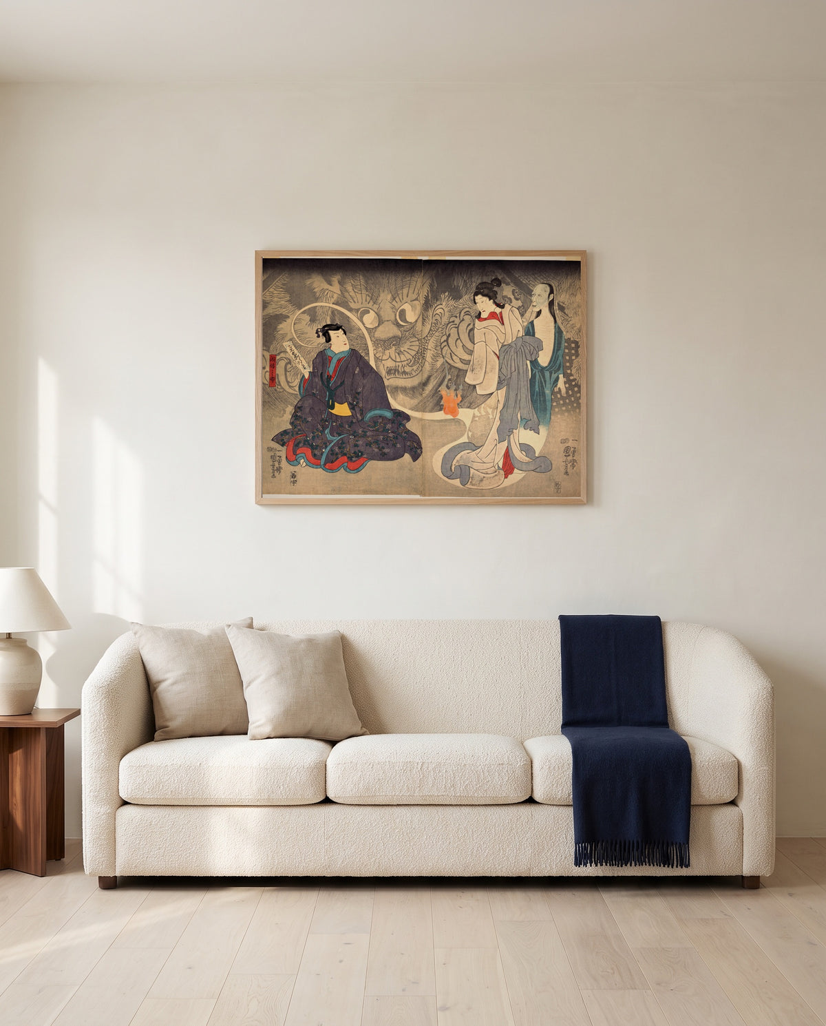 The Okazaki Cat Demon by Utagawa Kuniyoshi framed in natural oak above a cream sofa in a warm living room