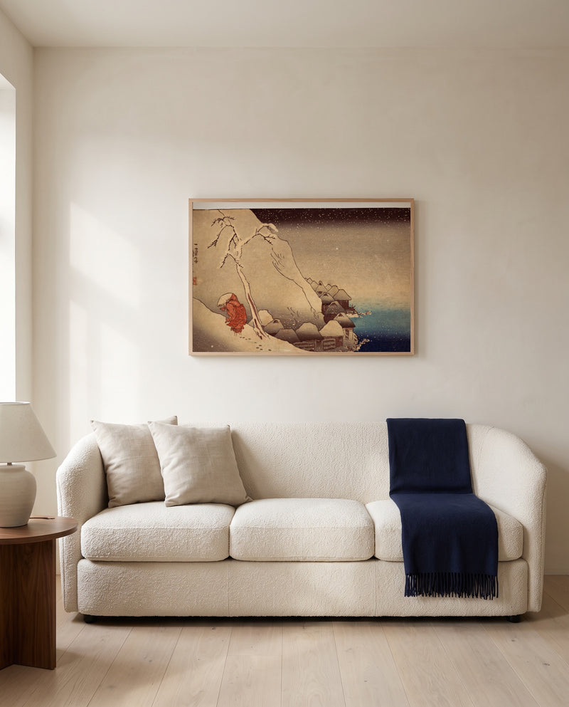Travelling in a Snowstorm by Utagawa Kuniyoshi framed in natural oak above a cream sofa in a warm living room