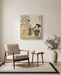 Woman with a Cat by Utagawa Kuniyoshi as a stretched canvas above a linen lounge chair in a reading corner